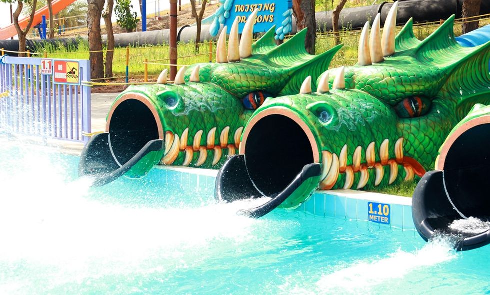Dragon-themed water slides leading into a pool at Dreamland Aqua Park