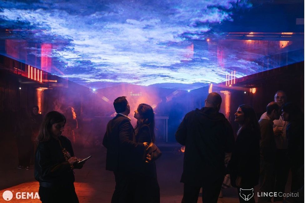 Dubbed “the tech event of the year,” Web Summit's post-conference networking events took place in a warehouse transformed by multimedia powered by GEMA and Panasonic projection. Image courtesy GEMA