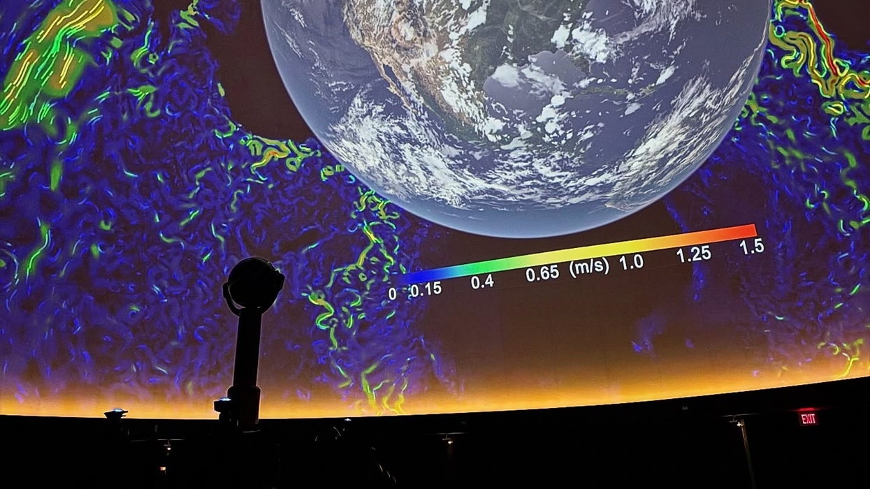 Earth displayed in dome theatre at the James S. McDonnell Planetarium, with colourful data overlay and scale.