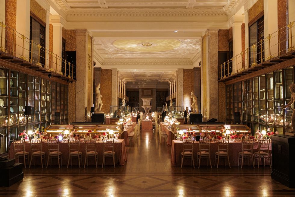 Elegant banquet in a grand hall with statues, art, and elaborate table settings at the British Museum