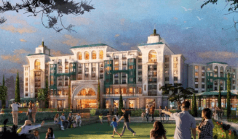 Elegant hotel exterior with people enjoying a scenic, grassy courtyard at sunset.