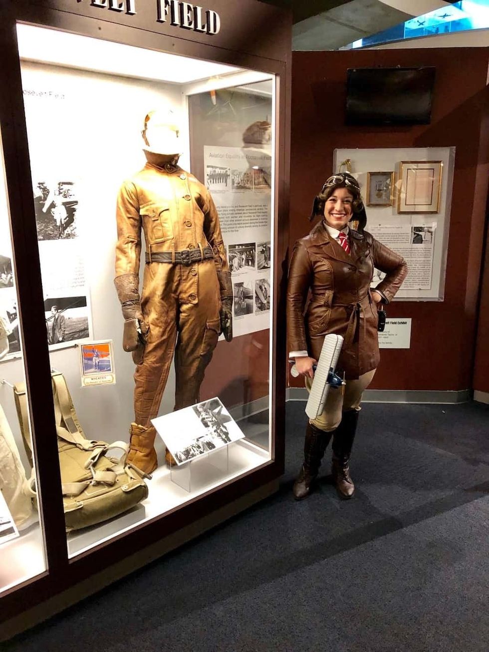 Elysia Segal as Elinor Smith next to flying suit immersive theatre in LBE