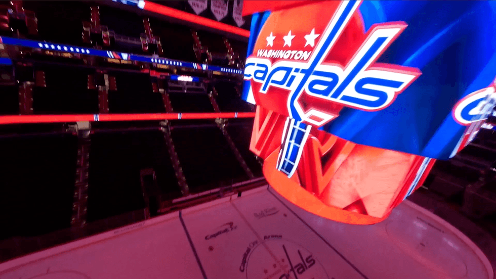 Empty hockey arena with Washington Capitals logo on the scoreboard.