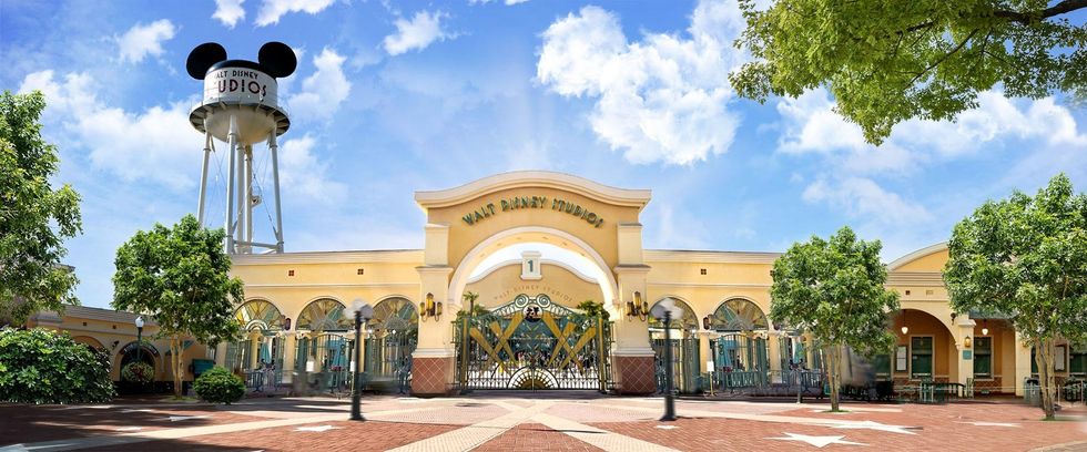 Entrance of Walt Disney Studios at Disneyland Paris with Mickey Mouse water tower under a bright blue sky.