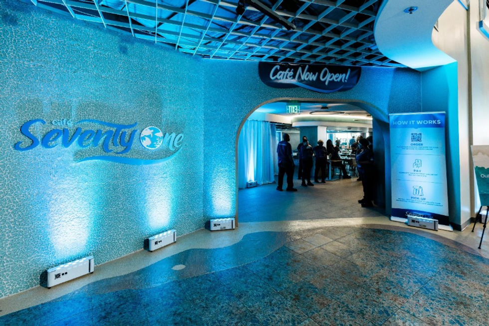 Entrance to Caf\u00e9 Seventy One, featuring blue walls and caf\u00e9-goers inside.