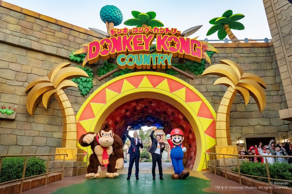 Entrance to Donkey Kong Country with Donkey Kong, Mario, and a person waving.