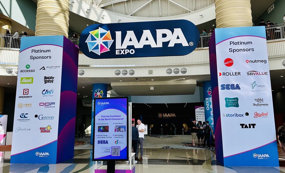 Entrance to IAAPA Expo with sponsor logos displayed on large pillars.