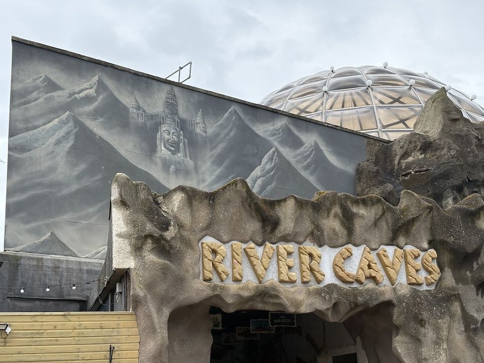 Entrance to "River Caves," with mountain mural and geodesic dome.