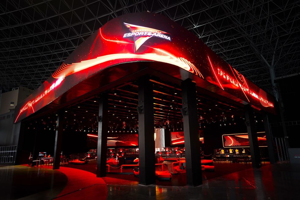 Esports arena with vibrant red lighting and futuristic design.