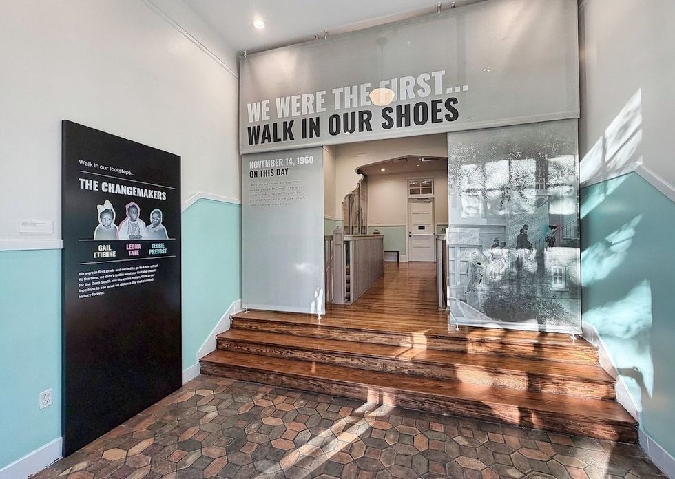 Exhibit entrance with "Walk In Our Shoes" slogan and photos of historical changemakers.
