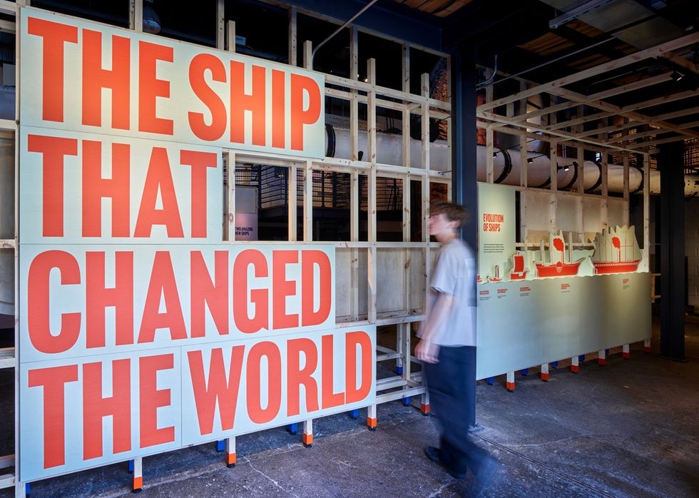 Exhibit: "The Ship that Changed the World" at SS Great Britain Experience, with ship evolution graphics, person walking by.