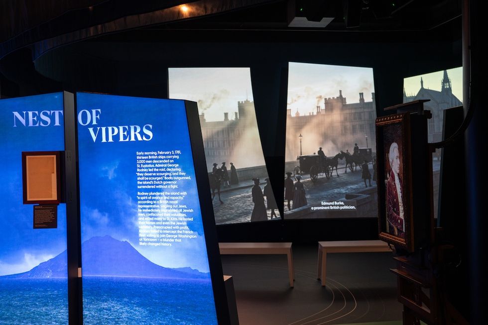 Exhibit with "Nest of Vipers" text and historical street scene projection, The First Salute exhibition
