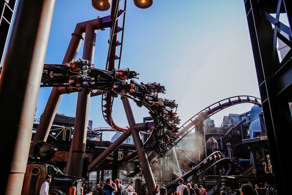 F.L.Y. roller coaster at Phantasialand with inverted track, riders upside down, under a clear blue sky.