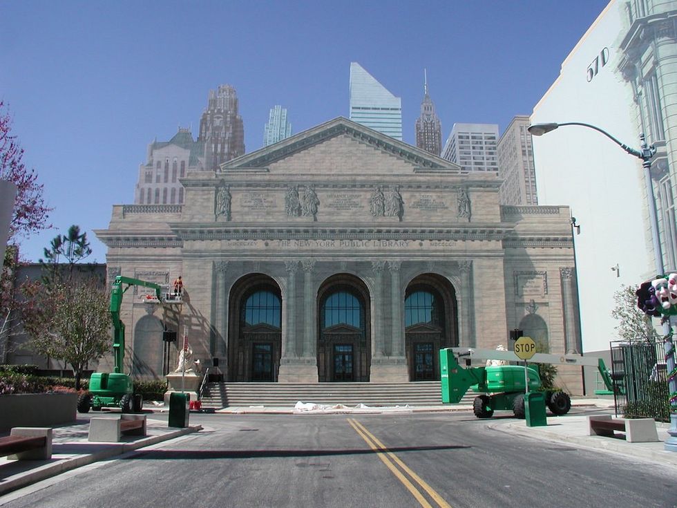 Facade of a library building with construction equipment in front.