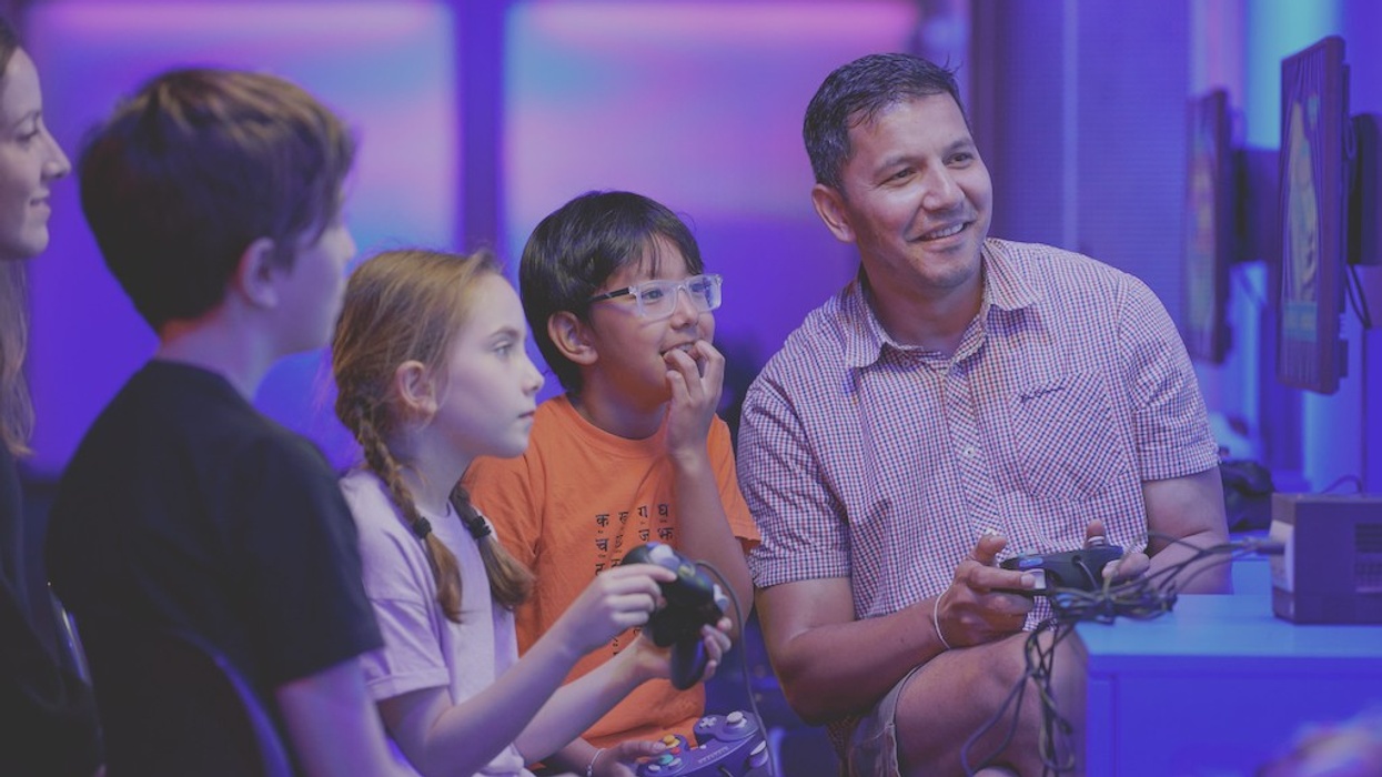 Families and friends enjoying a 4-player game in Power Up, the Science Museum’s hands-on gaming experience