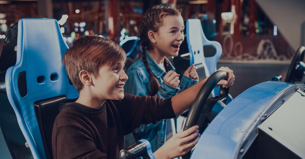 family-at-arcade-driving-game