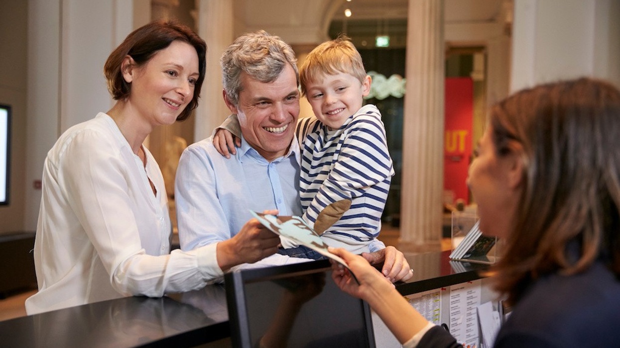 Family Buying Entry Tickets To Museum From Reception visitor research