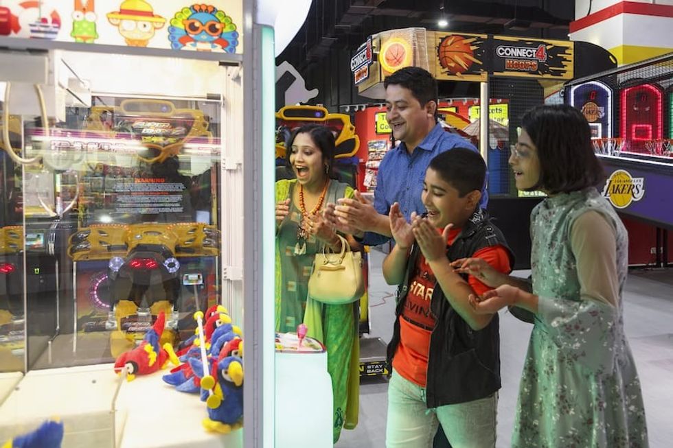 Family enjoying games at Bandai Namco FEC in Mumbai, with Intercard cashless tech