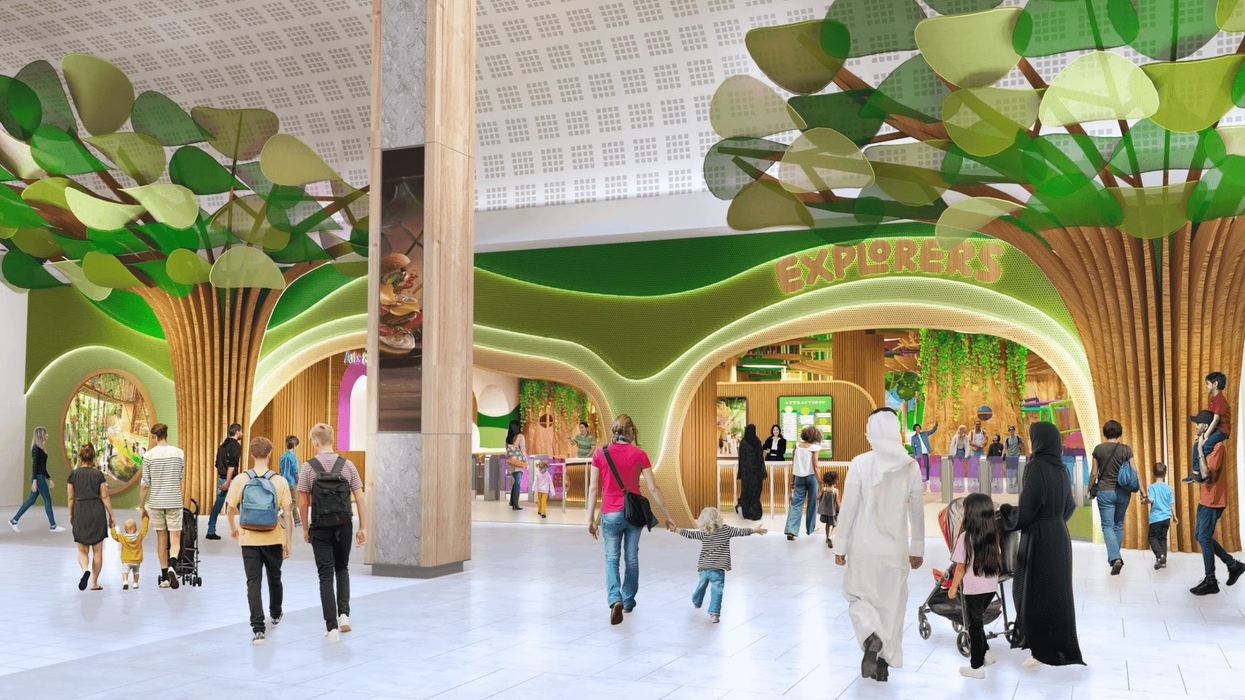 Family-friendly indoor playground with tree-themed decor and "Explorers" sign.