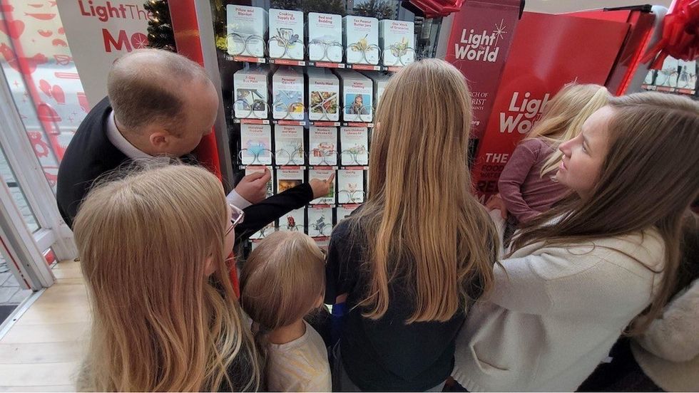 Family Gathered around Giving Machine lessons from charity fundraising