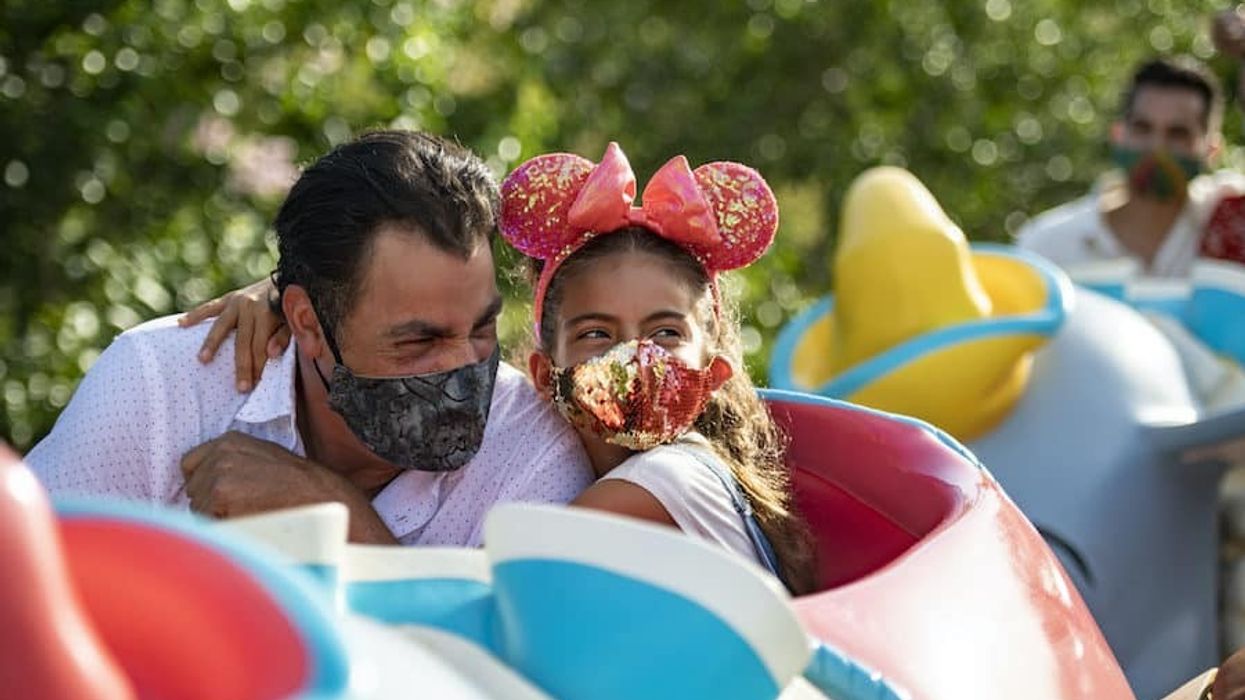 family-on-ride-at-Disneyland-in-masks storytelling after covid