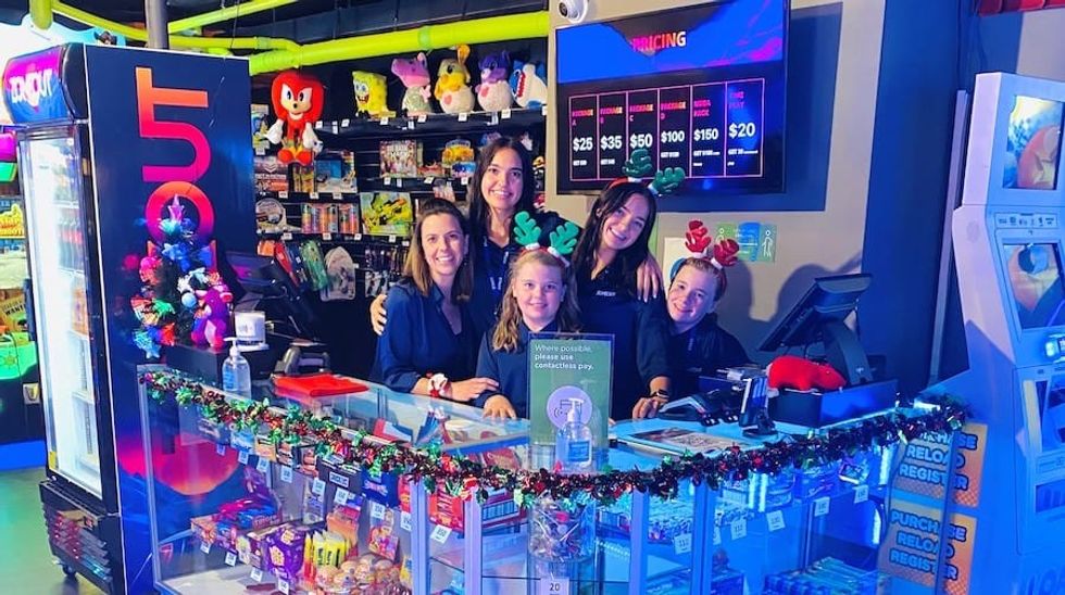 Family with several children poses inside arcade