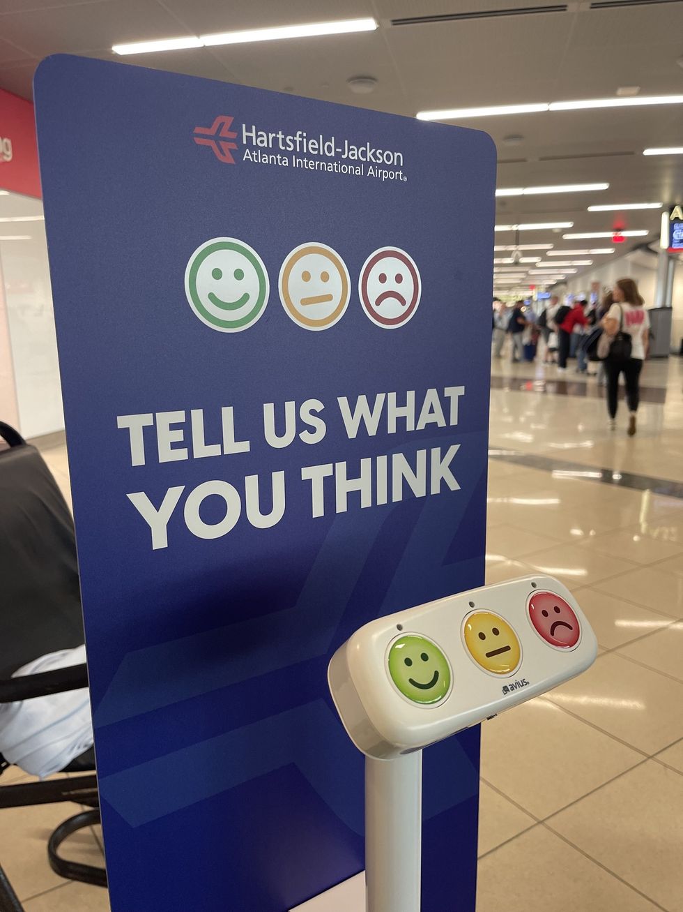 Feedback station at Hartsfield-Jackson Airport with smiley face buttons.