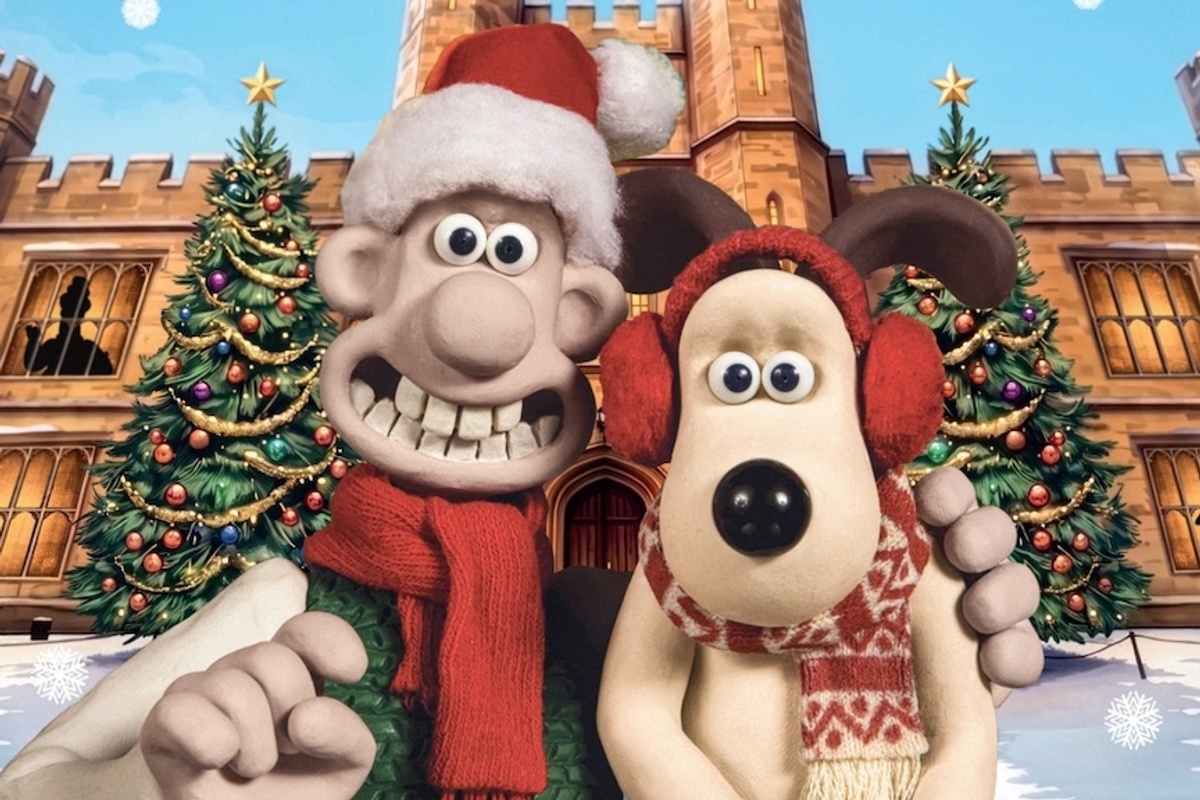 Festive Wallace and Gromit figures in front of Leeds Castle, with Christmas trees and snowflakes.