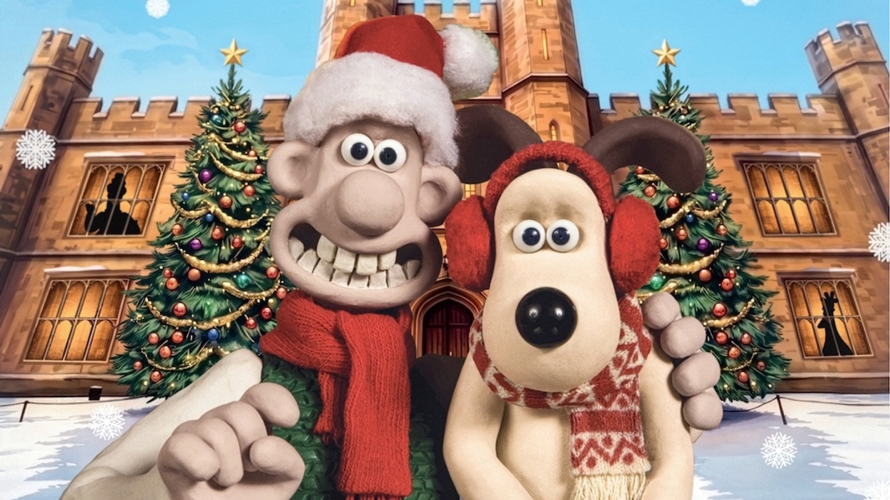 Festive Wallace and Gromit figures in front of Leeds Castle, with Christmas trees and snowflakes.