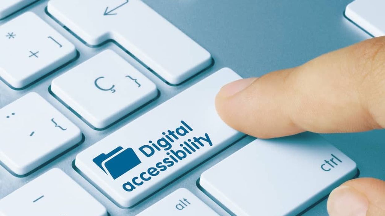 finger pressing button on keyboard that reads digital accessibility