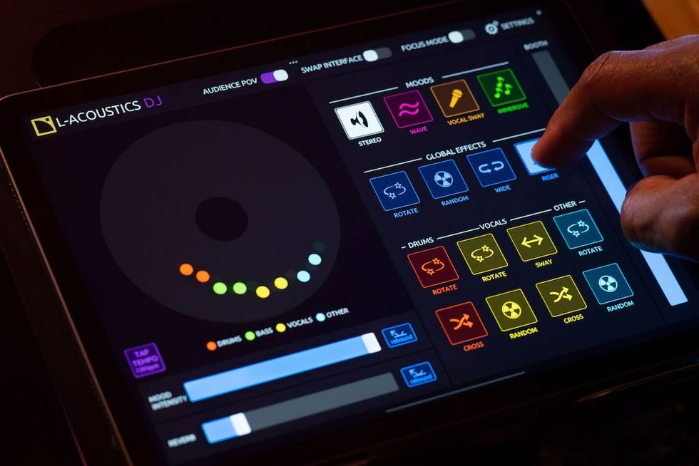 Finger tapping a digital DJ sound mixer on a touchscreen interface.