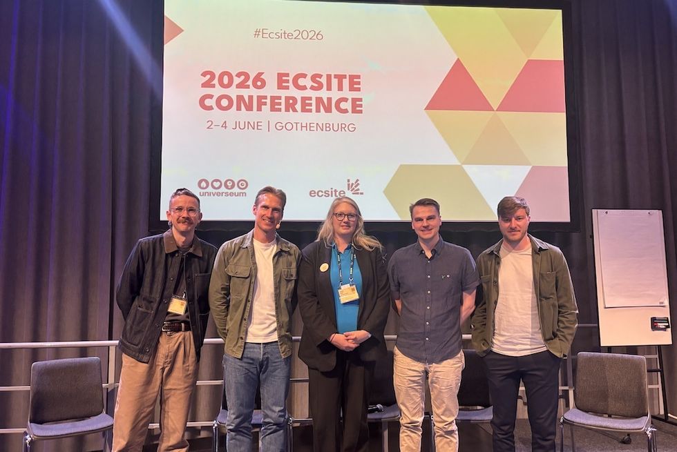 Five people standing in front of a sign for the 2026 Ecsite Conference in Gothenburg.