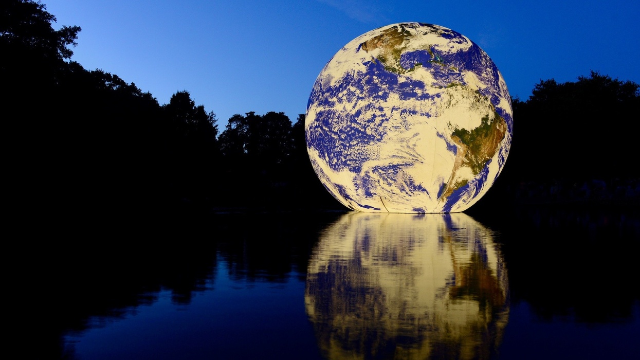 Floating Earth, Jersey, U.K. Queens valley reservoir. A floating 10 metre ball of our home planet, showing the fragility of our planet especially today during climate change.