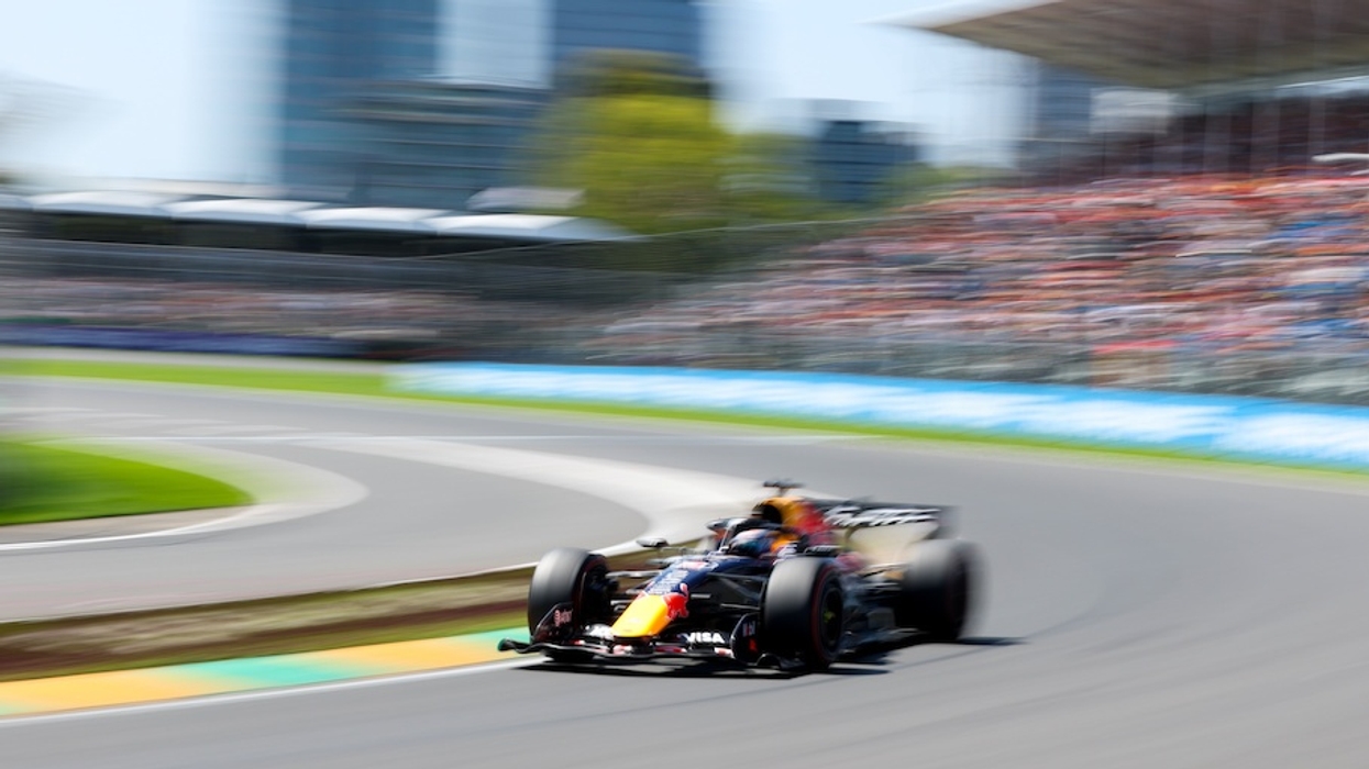 Formula 1 car racing on a track, blurred background suggests high speed.