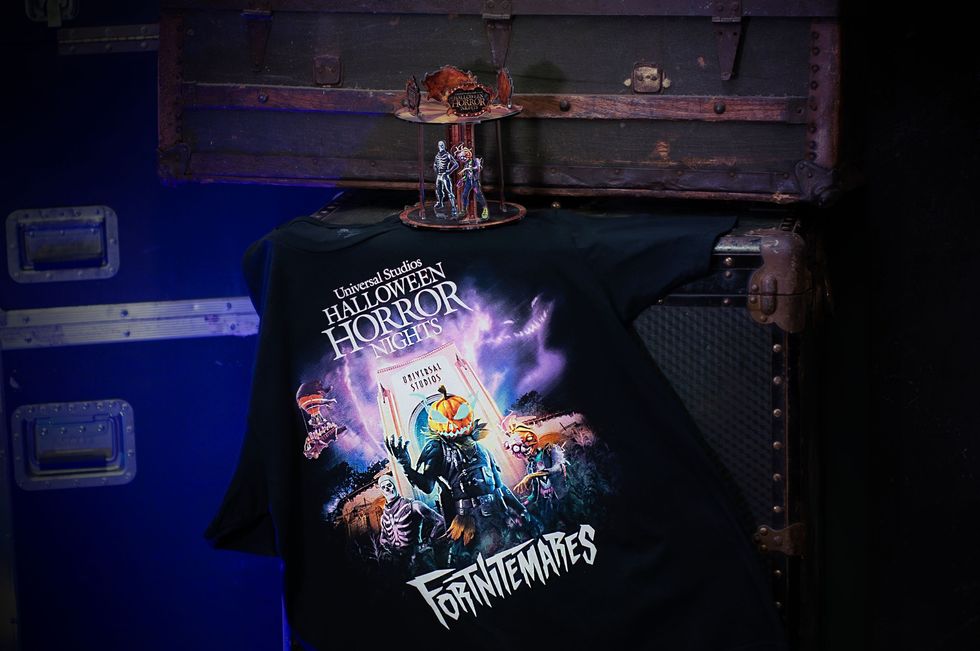 Fortnite Halloween shirt draped on a chest, with a small figure on top.