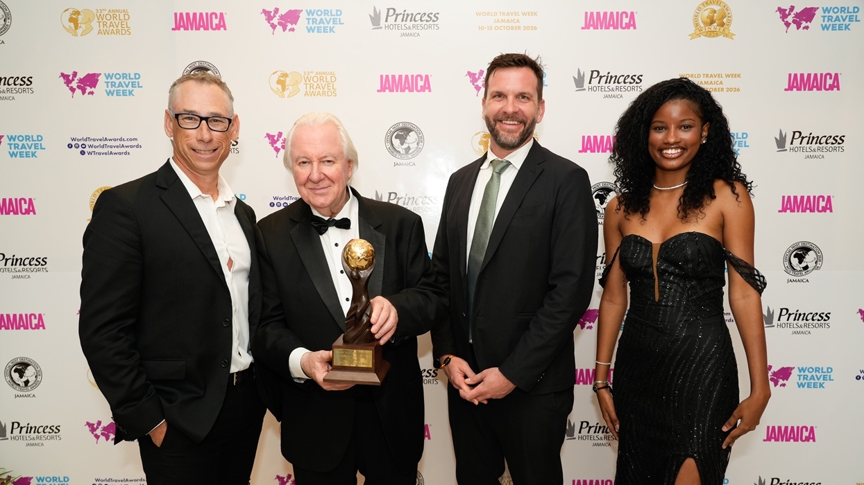 Four formally dressed people pose at the 2026 World Travel Awards, with one holding a trophy for Caribbean's Leading Water Park
