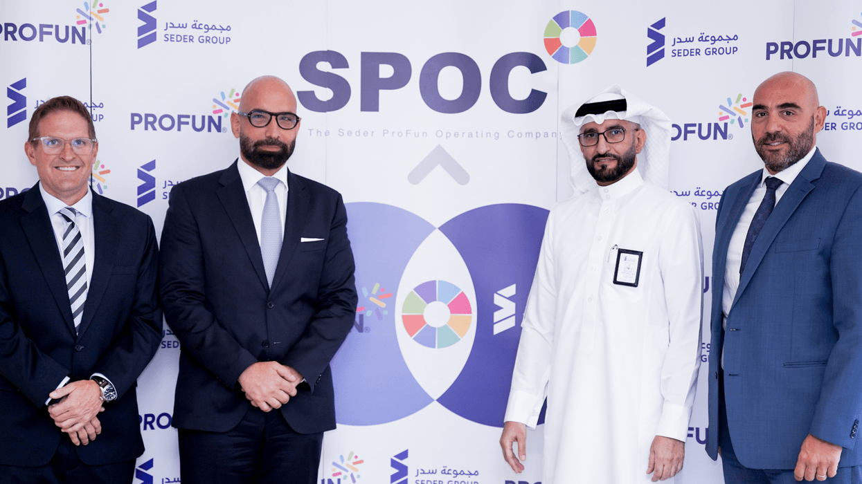 Four men in suits, standing in front of an SPOC backdrop.