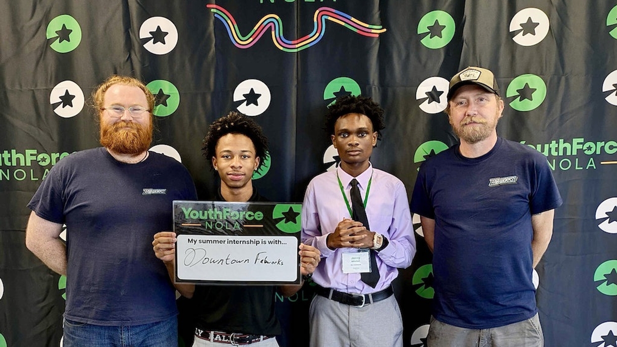 Four men pose at a YouthForce NOLA event; one holds an internship sign reading Downtow FabWorks
