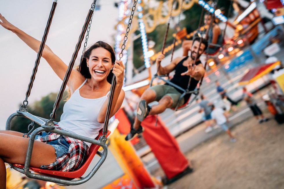 Friends-on-carousel-ride-at-amusement-park