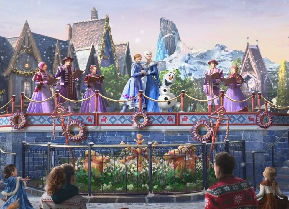 Frozen characters sing on a snowy stage, observed by an audience at Disneyland Paris