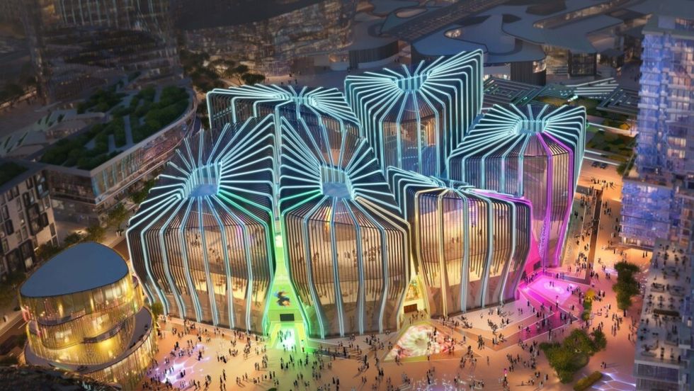 Futuristic building at Qiddiya with colorful lights and angular design, viewed from above at night.