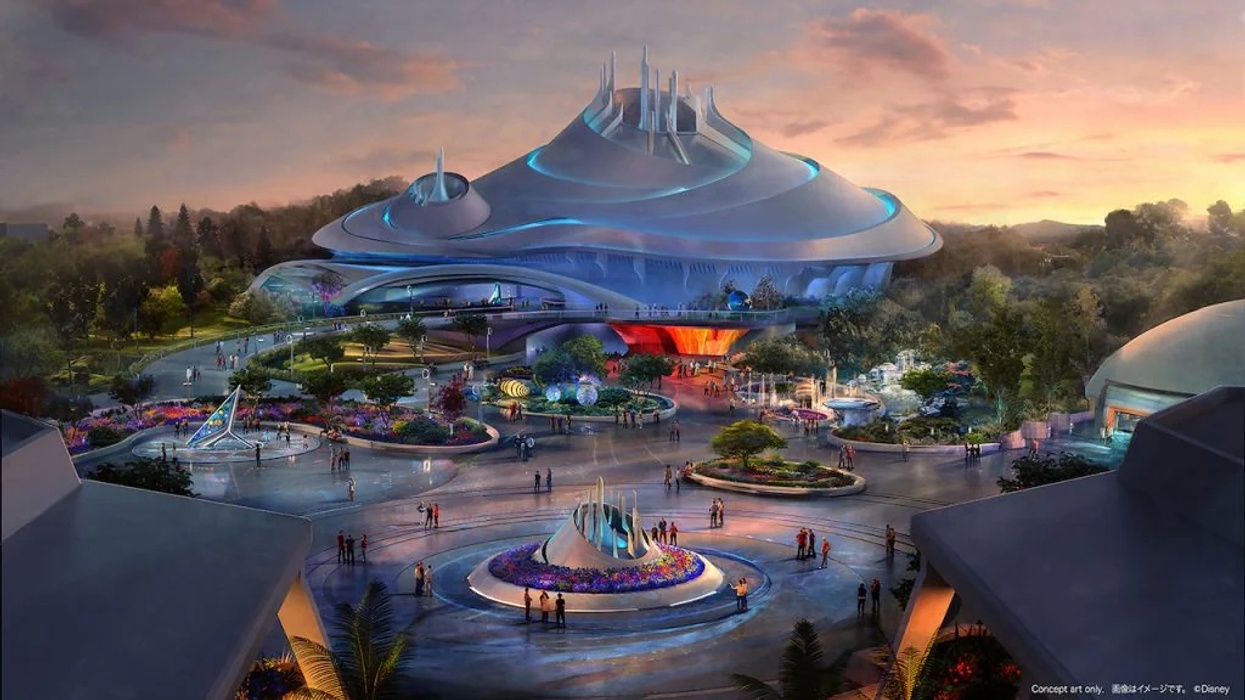 Futuristic building called Space Mountain with a dome and vibrant landscaping at sunset.