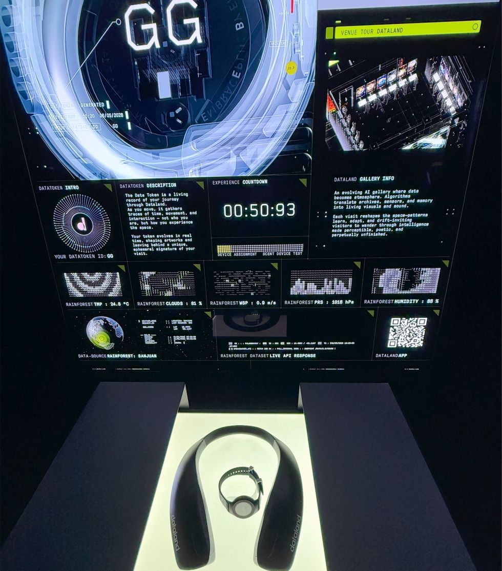 Futuristic data display with countdown, graphs, and a headset on a lit stand.