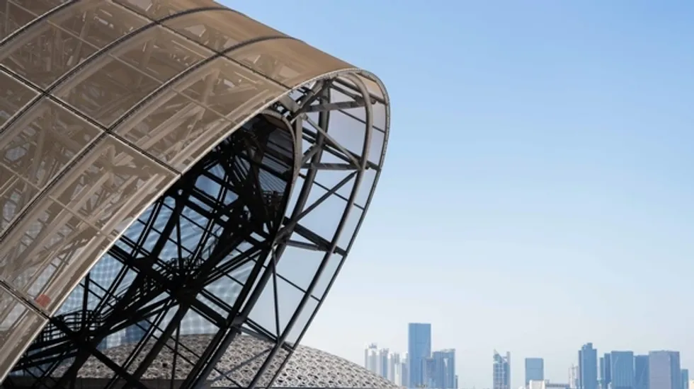 Futuristic dome structure with city skyline in the background.