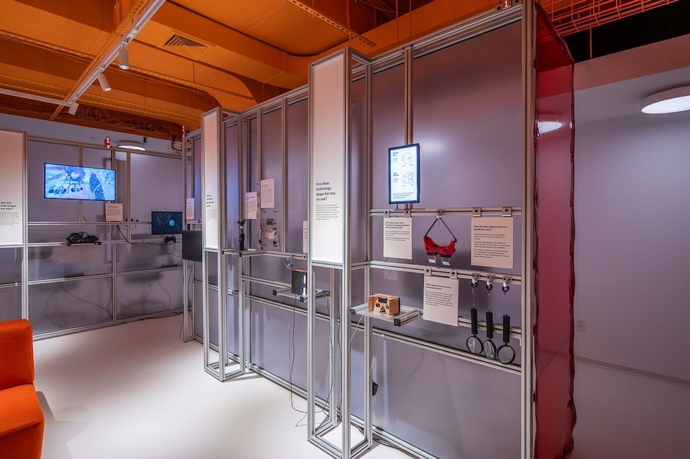 Futuristic exhibition space with VR headsets and interactive displays.