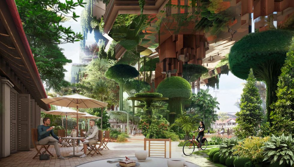 Futuristic green cityscape in Greater Sentosa with people seated and a cyclist surrounded by lush plants.