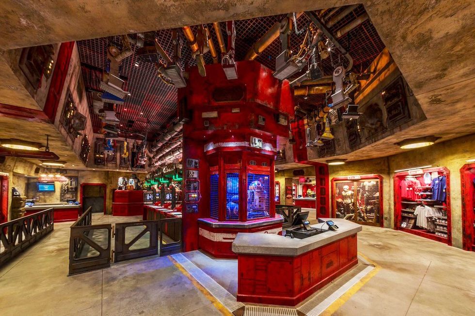 Futuristic, industrial-themed store interior with red accents and merchandise displays.