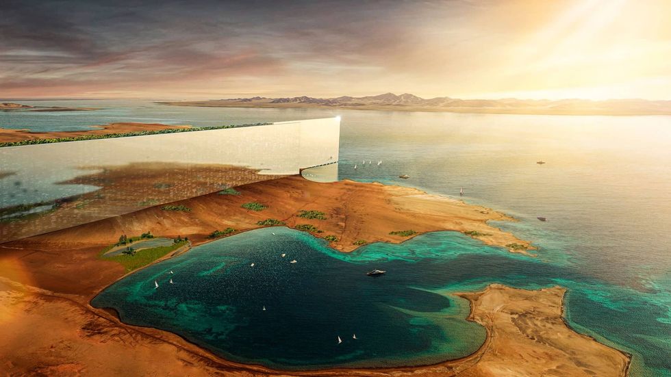 Futuristic mirrored building called The Line at Neom by a coastal desert landscape with clear blue waters