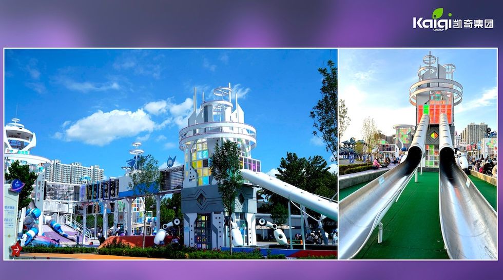 Futuristic playground with towering slides under a bright blue sky.