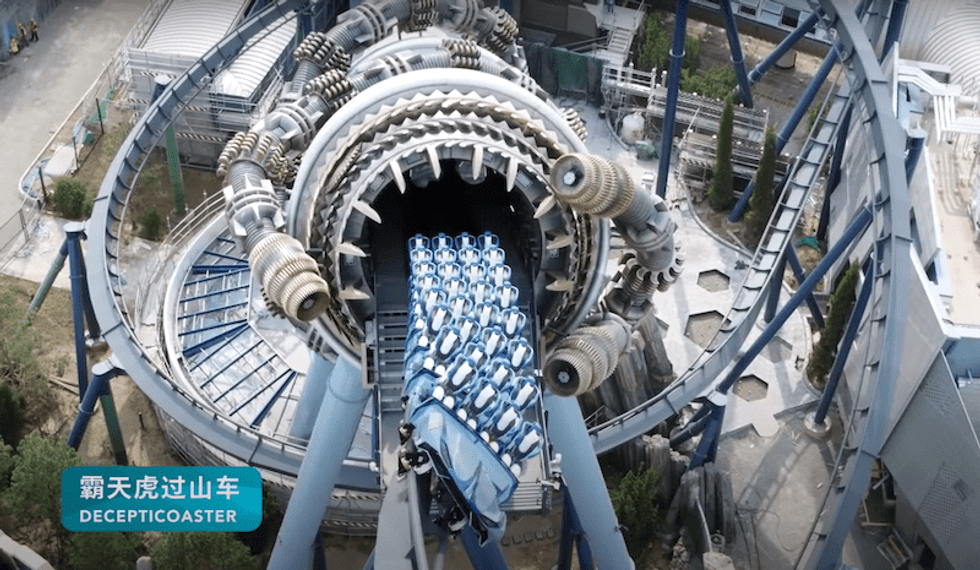 Futuristic roller coaster with a swirling tunnel entrance, labeled "Decepticoaster".